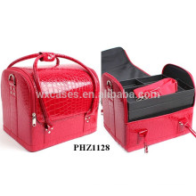red crocodile bag with 4 removable trays inside and one shoulder strap